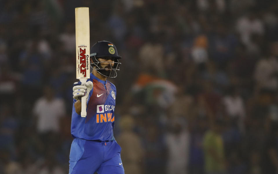 India's captain Virat Kohli raises his bat after scoring fifty runs during the second T20 international match between India and South Africa, in Mohali, India, Wednesday, Sept. 18, 2019. (AP Photo/Altaf Qadri)