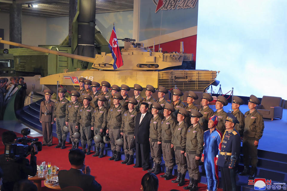 In this photo provided by the North Korean government, North Korean leader Kim Jong-un, centre, poses for a group photo with fighter pilots who made the demonstration flight on Monday. Source: Korean Central News Agency/Korea News Service via AP