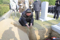 In this photo provided by the North Korean government, North Korean leader Kim Jong Un covers the coffin of Marshal of the Korean People's Army Hyon Chol Hae with earth at a cemetery in Pyongyang, North Korea Sunday, May 22, 2022. Independent journalists were not given access to cover the event depicted in this image distributed by the North Korean government. The content of this image is as provided and cannot be independently verified. Korean language watermark on image as provided by source reads: "KCNA" which is the abbreviation for Korean Central News Agency. (Korean Central News Agency/Korea News Service via AP)