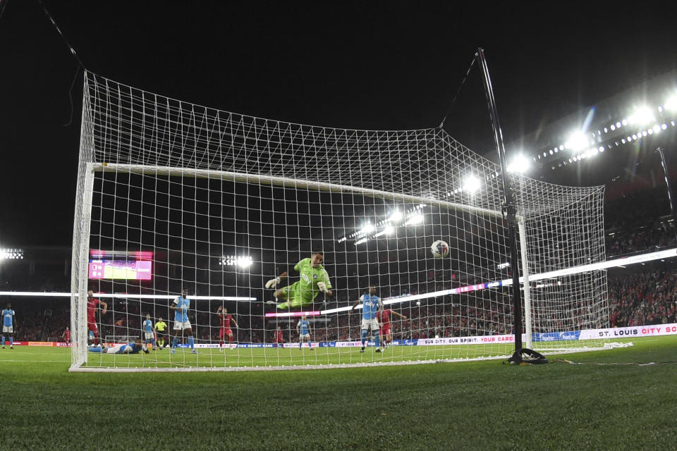 Charlotte FC goalkeeper Pablo Sisniega, front center, is unable to stop a goal by St. Louis City SC during the first half of an MLS soccer match Saturday, March 4, 2023, in St. Louis. (AP Photo/Joe Puetz)