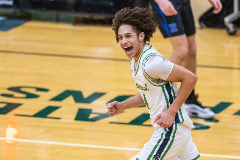 Indianapolis Cathedral High School junior Deric Cannady (4) reacts after scoring a 3-point basket during the first half of an Indianapolis Boys Basketball Tournament semi-final game against Heritage Christian High School, Saturday, Jan. 20, 2024, at Arsenal Tech High School.