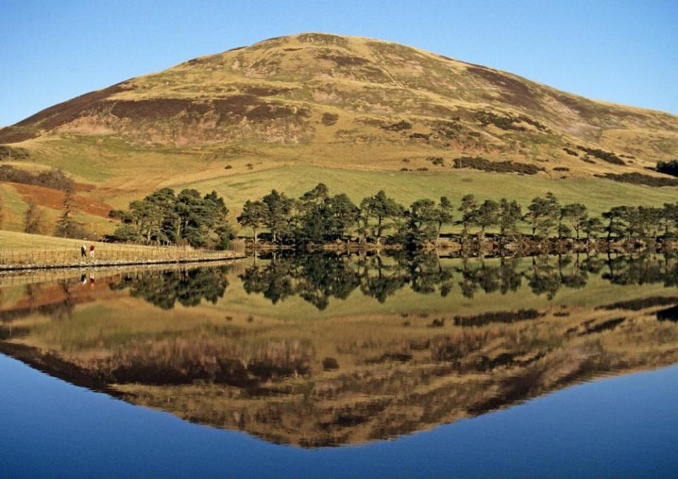 Walkers passing Glencorse Reservoir