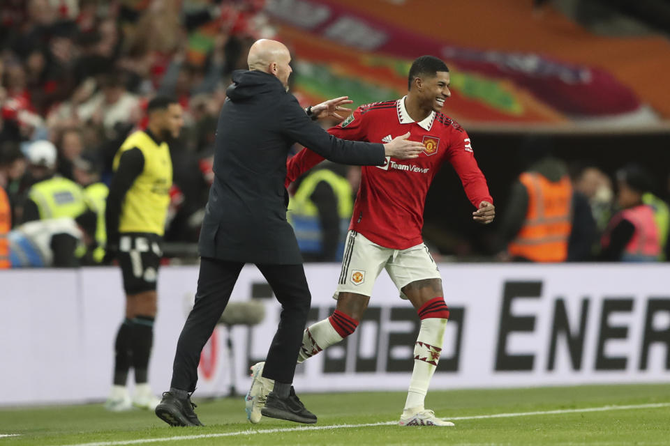 Manchester United's head coach Erik ten Hag, left, and Manchester United's Marcus Rashford celebrate after winning the English League Cup final soccer match between Manchester United and Newcastle United at Wembley Stadium in London, Sunday, Feb. 26, 2023. Manchester United won 2-0. (AP Photo/Scott Heppell)