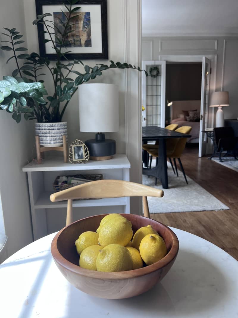 lemons in wood bowl on dining nook table
