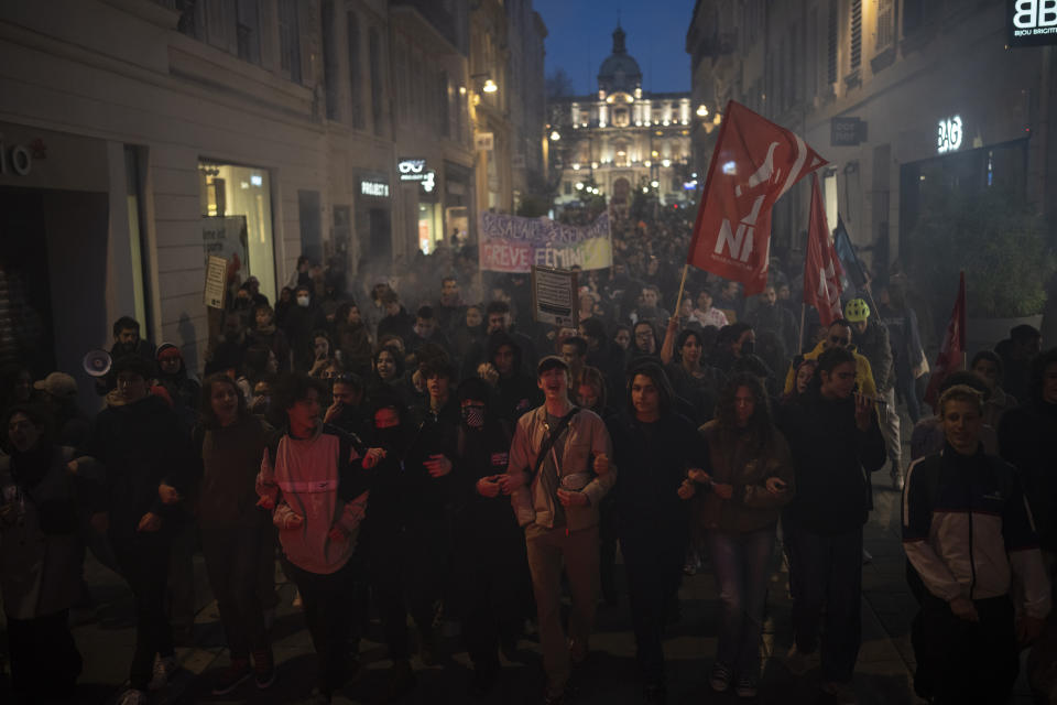 Protesters march during a demonstration in Marseille, southern France, Thursday, March 16, 2023. French President Emmanuel Macron has shunned parliament and imposed a highly unpopular change to the nation's pension system, raising the retirement age from 62 to 64. (AP Photo/Daniel Cole)