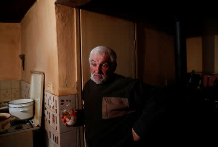 Istvan Barna, 61, stands at his home in the village of Bacsszentgyorgy, Hungary, April 3, 2018. "My brother lives in Germany, and even he wants to come back. He says every evening when you go to the supermarket it fills up with migrants. He feels unsafe. We are safer here," said Barna. REUTERS/Bernadett Szabo