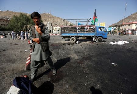 An Afghan man walks at the site of a suicide attack in Kabul, Afghanistan July 23, 2016. REUTERS/Omar Sobhani