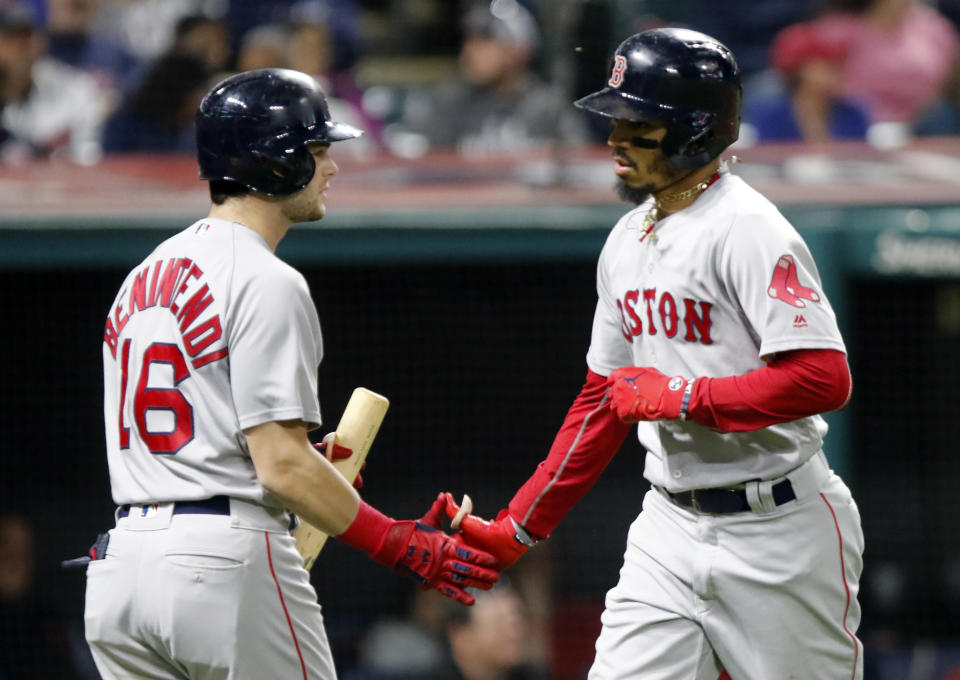 Boston Red Sox's Andrew Benintendi (16) greets Mookie Betts after his solo home run off of Cleveland Indians starting pitcher Adam Plutko in the fifth inning of a baseball game, Sunday, Sept. 23, 2018, in Cleveland. (AP Photo/Tom E. Puskar)