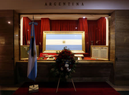 Flowers are placed in front of an Argentine national flag during a ceremony in honour of the five Argentine citizens of Rosario who were killed in the truck attack in New York on October 31, at the National Flag Memorial in Rosario, Argentina November 2, 2017. REUTERS/Marcos Brindicci