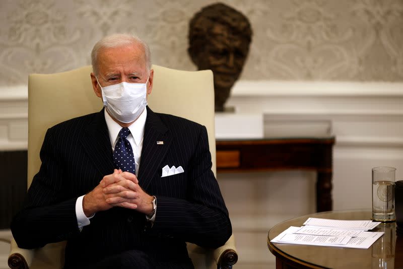 FILE PHOTO: U.S. President Joe Biden accompanied by U.S. Vice President Kamala Harris and Treasury Secretary Janet Yellen (not pictured) attends a meeting with business leaders at the Oval Office of the White House in Washington, U.S.