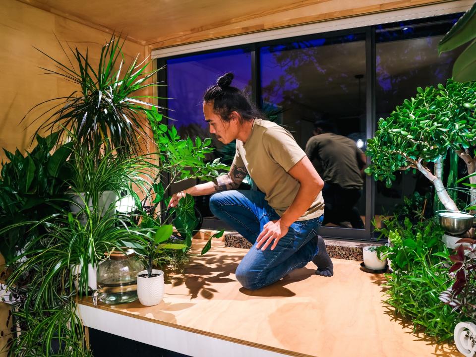 Fabian Low gardening inside his house.