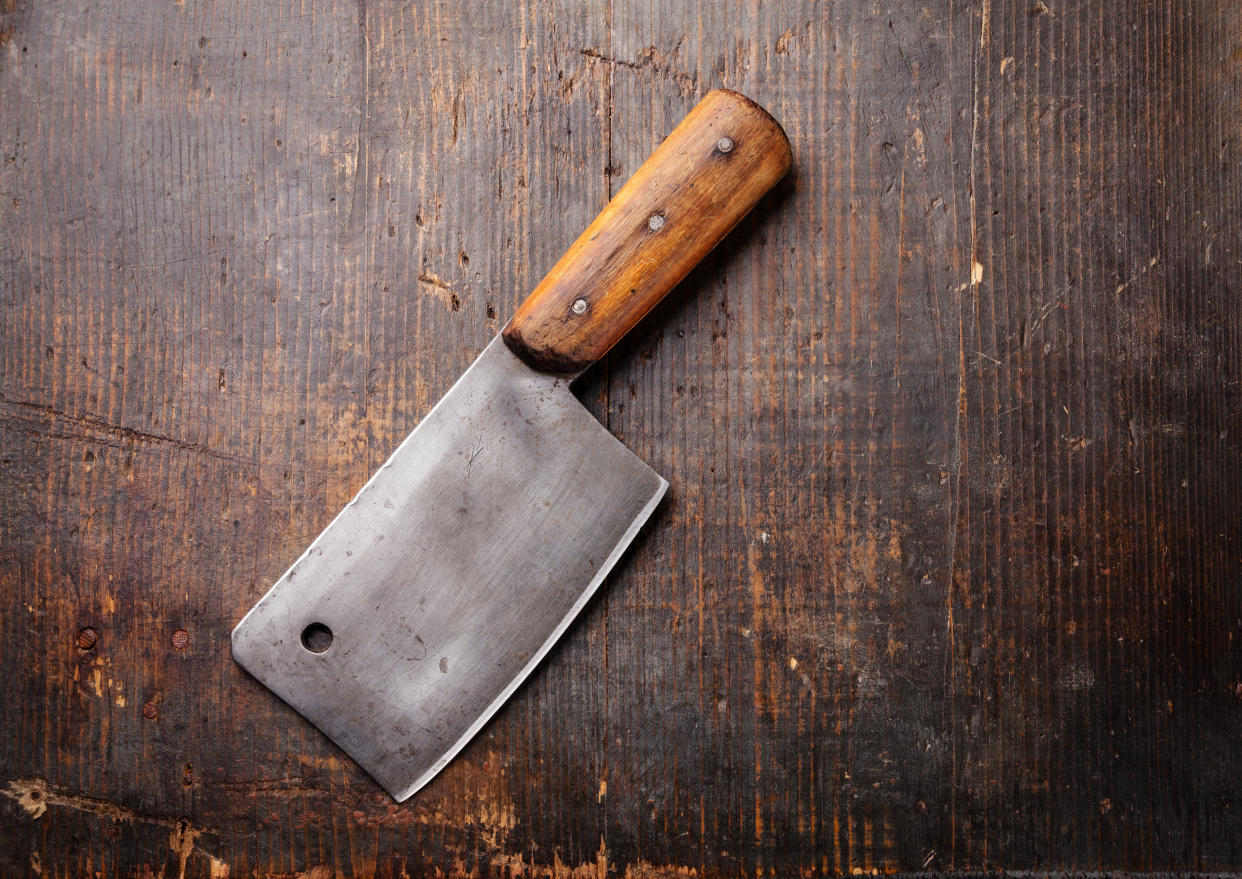 Meat cleaver on dark wooden background