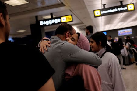 A Saudi family embraces as members arrive at Washington Dulles International Airport after the U.S. Supreme Court granted parts of the Trump administration's emergency request to put its travel ban into effect later in the week pending further judicial review, in Dulles, Virginia, U.S., June 26, 2017. REUTERS/James Lawler Duggan