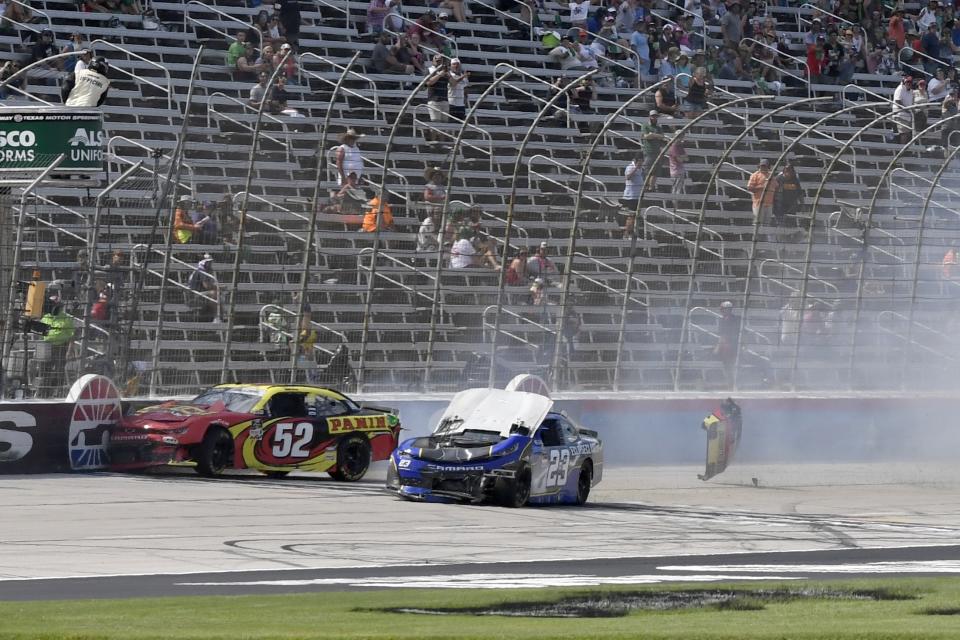 Gray Gaulding (52) and Tanner Berryhill (23) crash on the front stretch during a NASCAR Xfinity Series auto race at Texas Motor Speedway in Fort Worth, Texas, Saturday, June 12, 2021. (AP Photo/Larry Papke)