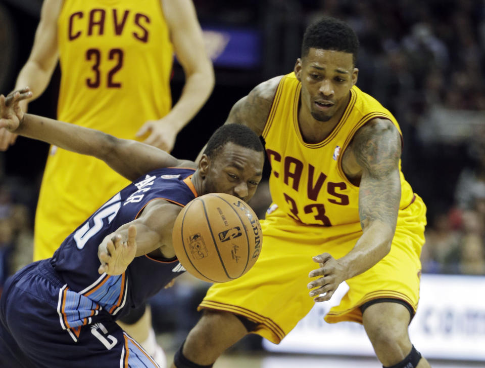 Charlotte Bobcats' Kemba Walker, front left, knocks the ball away from Cleveland Cavaliers' Alonzo Gee (33) in the second quarter of an NBA basketball game on Saturday, April 5, 2014, in Cleveland. (AP Photo/Mark Duncan)