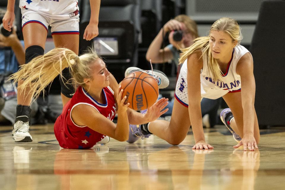 South Future All-Star Chloe Spreen (4), a junior from Bedford North Lawrence High School, left, and North Future All-Star Ava Ziolkowski (9), a junior from Crown Point High School, battle for a loose ball during the first half of a girls Indiana High School Future All-Stars basketball game, Saturday, June 10, 2023, at Gainbridge Fieldhouse, in Indianapolis.