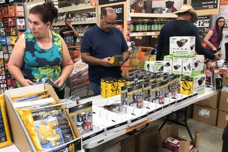 People shop for supplies at a Home Depot store ahead of the arrival of Hurricane Dorian in Miami