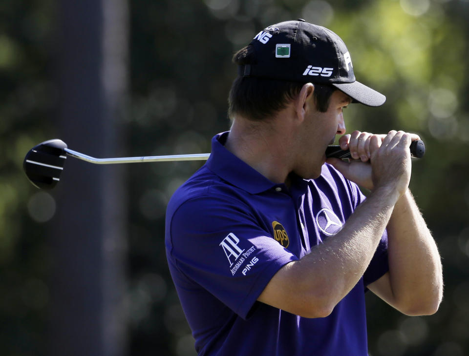 Louis Oosthuizen, of South Africa, bites his putter after missing a putt on the 14th green during the first round of the Masters golf tournament Thursday, April 10, 2014, in Augusta, Ga. (AP Photo/Darron Cummings)