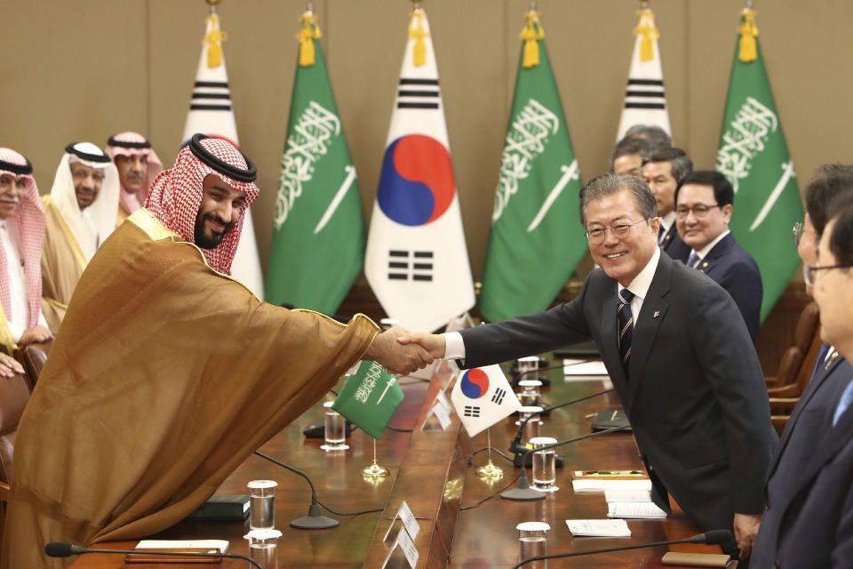 South Korean President Moon Jae-in, right, shakes hands with Saudi Crown Prince Mohammed bin Salman during a meeting at the presidential Blue House, Wednesday, June 26, 2019, in Seoul, South Korea. Bin Salman is visiting South Korea for two days - the first time by an heir to the throne of Saudi Arabia since 1998. (Chung Sung-Jun/Pool Photo via AP)