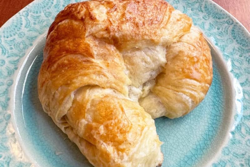 Croissant on a teal blue plate