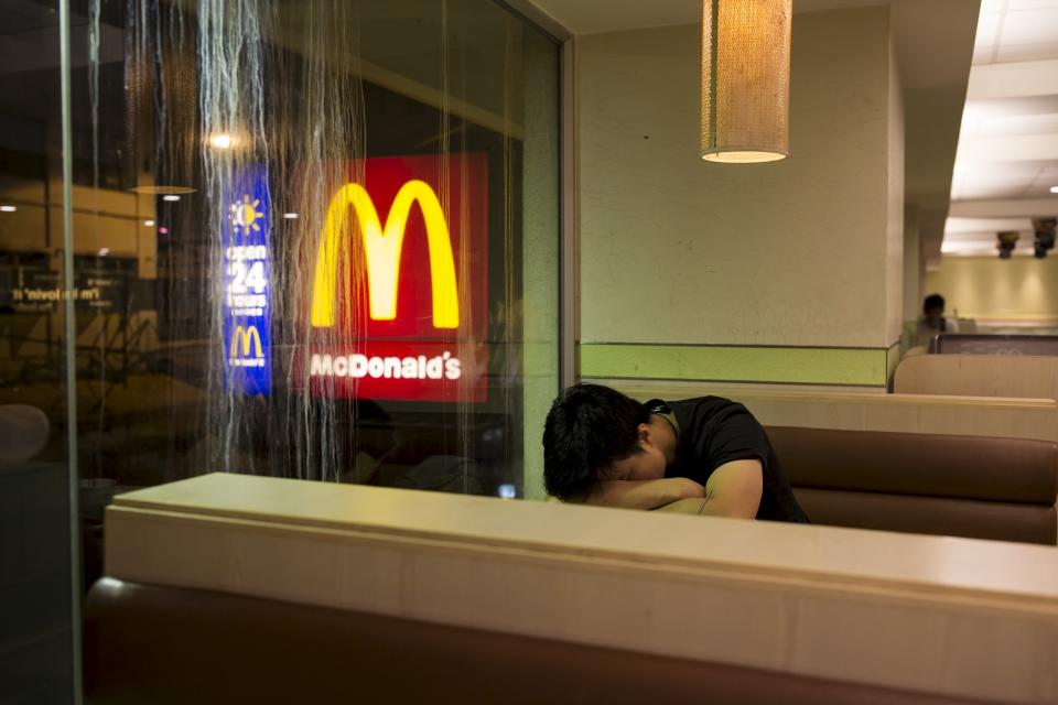 A man sleeps at a 24-hour McDonald's restaurant in Hong Kong, China November 10, 2015. A large number of homeless people sleeping on the street has long been been a problem in Hong Kong mainly due to its high rent and soaring property. In recent years, McDonald's 24-hour fast food shops opening all over the city have become popular alternatives for people, know as McRefugees or McSleepers, to spend the night in a safer and more comfortable way than on the street. Picture taken on November 10, 2015. McDonaldâ€™s Hong Kong said in a statement that it is accommodating to people staying long in the restaurant for their own respective reasons, while striking a good balance to ensure that customers enjoy their dining experience. REUTERS/Tyrone Siu