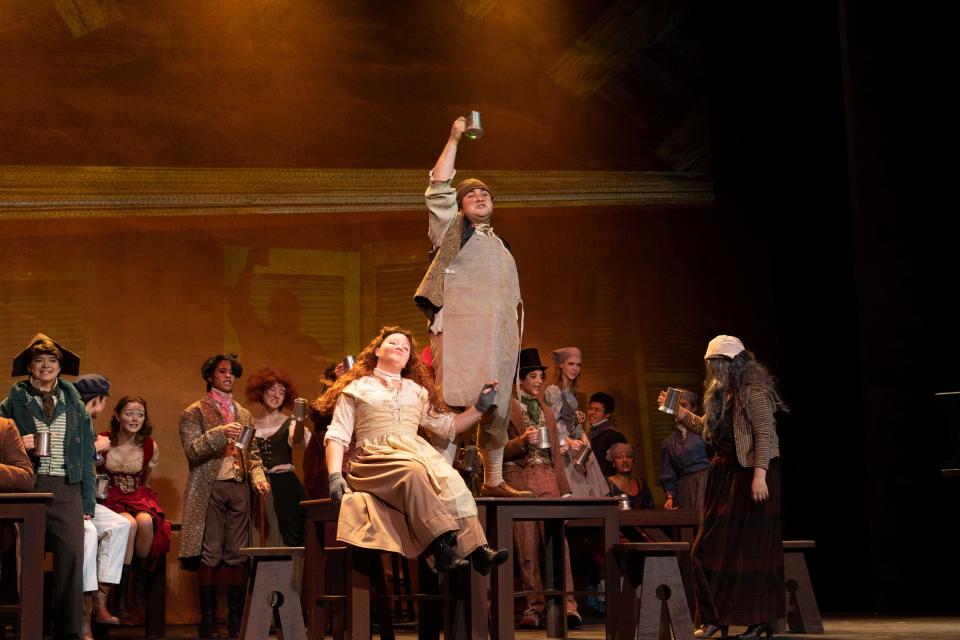 Gabriel Ebeling, standing, and Hope Green as the innkeepers Monsieur and Madame Thenardier are pictured in a scene from "Les Miserables (School Edition)" at the Croswell Opera House.