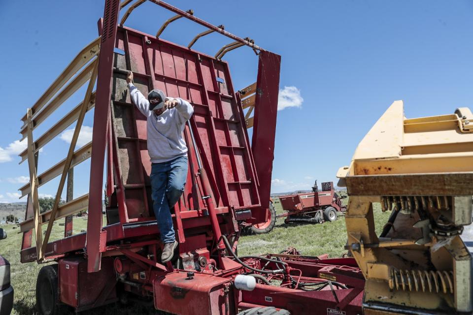 Paul Crawford prepares to run his hay bail retriever.