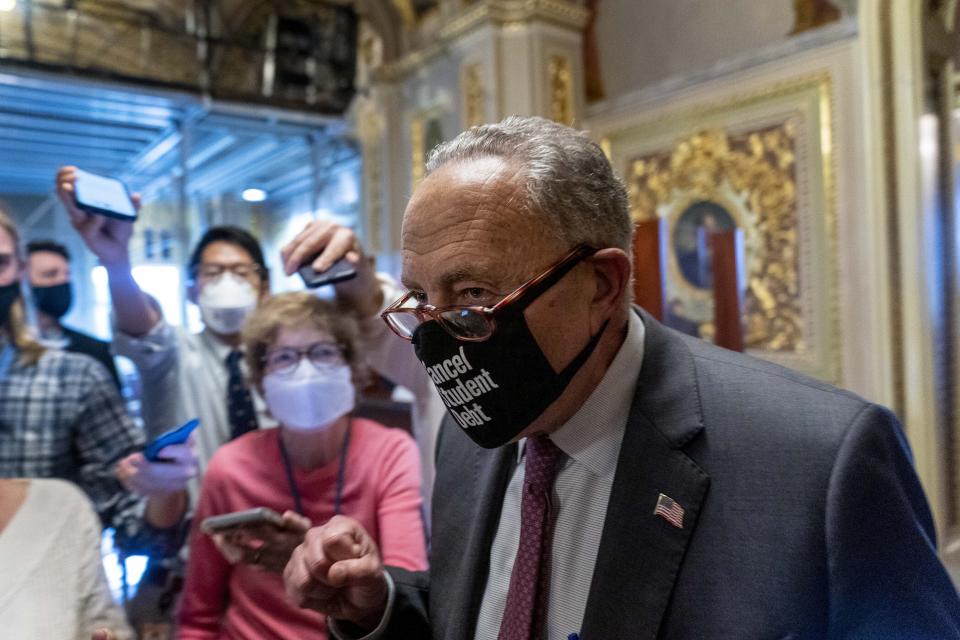 Senate Majority Leader Sen. Chuck Schumer of N.Y., walks out of a Senate Democratic meeting pumping his fist at the Capitol in Washington, Wednesday, Oct. 6, 2021, as a showdown looms with Republicans over raising the debt limit. (AP Photo/Andrew Harnik)