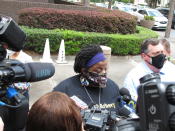 Thea Brooks speaks with reporters Tuesday, May 11, 2021, following a court hearing for three men charged with federal hate crimes in the slaying of her nephew, Ahmaud Arbery, in Brunswick, Ga. Justice Department prosecutors say Arbery was targeted because he was Black when he was chased and fatally shot by white men who saw him running in their neighborhood on Feb. 23, 2020. All three defendants pleaded not guilty to hate crime charges before a U.S. magistrate judge. They are also charged with murder in a Georgia state court. (AP Photo/Russ Bynum)