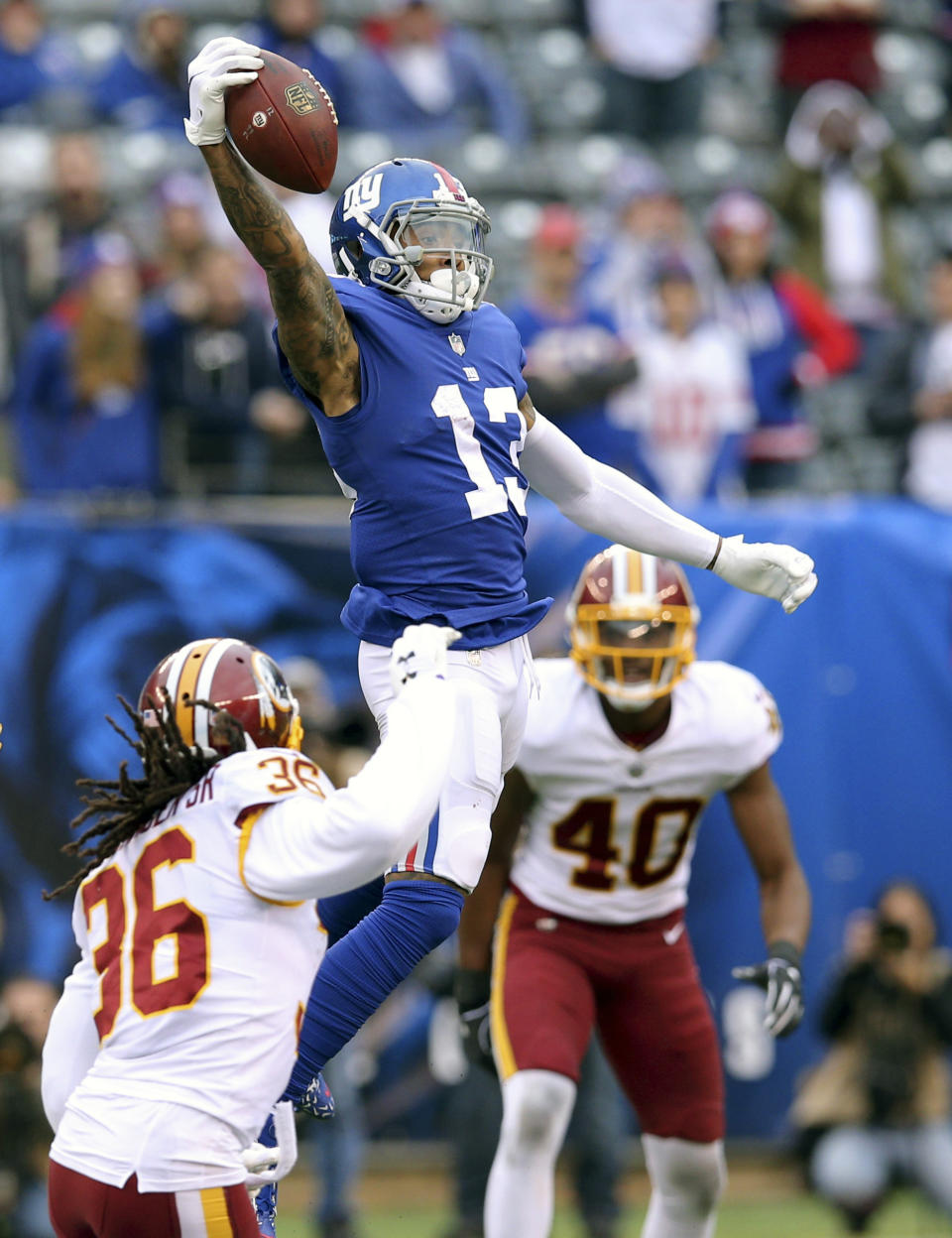 FILE - In this Oct. 28, 2018, file photo, New York Giants wide receiver Odell Beckham Jr. (13) makes a one handed catch against Washington Redskins safety D.J. Swearinger (36) and linebacker Josh Harvey-Clemons (40) during an NFL football game, in East Rutherford, N.J. No longer a punching bag, the Browns are punching back. From hopeless to hopeful. Finally. In landing Beckham, one of the game’s most electrifying players, the Browns have risen from the deepest depths imaginable in just a year. (AP Photo/Brad Penner, File)