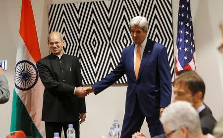 U.S. Secretary of State John Kerry shakes hands with India's minister of environment, forest and climate change Anil Madhav Dave before bilateral meeting to promote U.S. climate and environmental goals, at the Meeting of the Parties to the Montreal Protocol on the elimination of hydro fluorocarbons (HFCs) use in Rwanda's capital Kigali October 14, 2016. REUTERS/James Akena