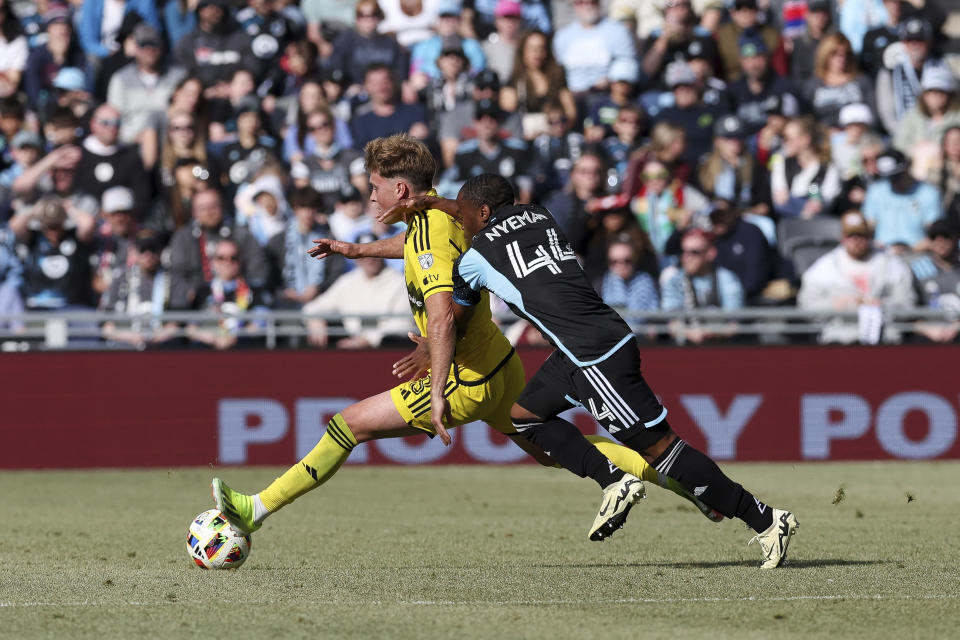 Columbus Crew midfielder Aidan Morris (8) controls the ball against Minnesota United midfielder Moses Nyeman (44) during the second half of an MLS soccer match, Saturday, March 2, 2024, in St. Paul, Minn. The game ended in a 1-1 draw. (AP Photo/Stacy Bengs)