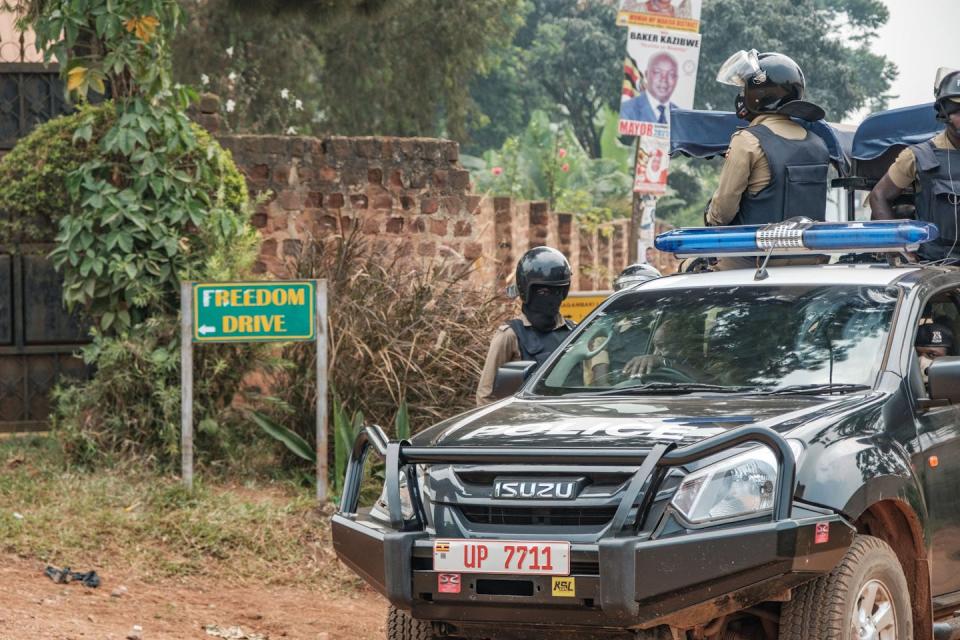 A patrol car of the Ugandan police on Jan. 20, 2021, stationed outside the compound of Ugandan opposition leader Bobi Wine, who was under effective house arrest. <a href="https://www.gettyimages.com/detail/news-photo/patrol-car-of-the-ugandan-police-is-seen-stationed-outside-news-photo/1230687986?adppopup=true" rel="nofollow noopener" target="_blank" data-ylk="slk:Sumi Sadurni/AFP via Getty Images;elm:context_link;itc:0;sec:content-canvas" class="link ">Sumi Sadurni/AFP via Getty Images</a>
