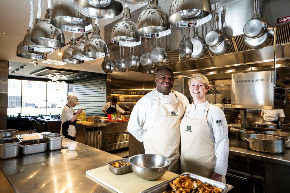 Executive chef Ian Robertson, left, and his wife Jess pose for a portrait in the kitchen at Oak Park restaurant on Thursday, November 30, 2023 in Des Moines.