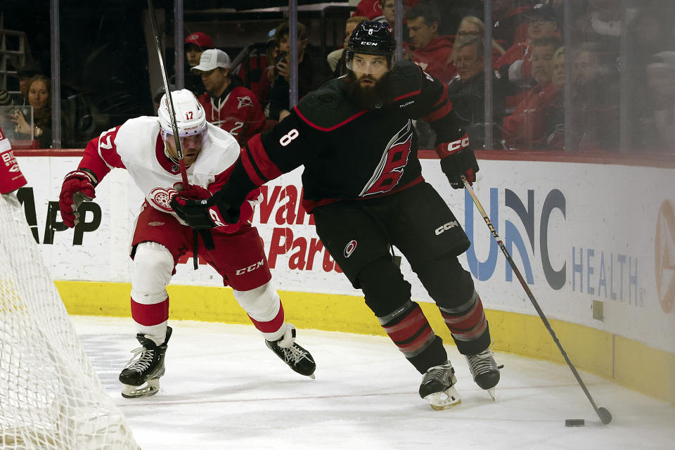 Carolina Hurricanes' Brent Burns (8) protects the puck from Detroit Red Wings' Daniel Sprong (17) during the second period of an NHL hockey game in Raleigh, N.C., Friday, Jan. 19, 2024. (AP Photo/Karl B DeBlaker)