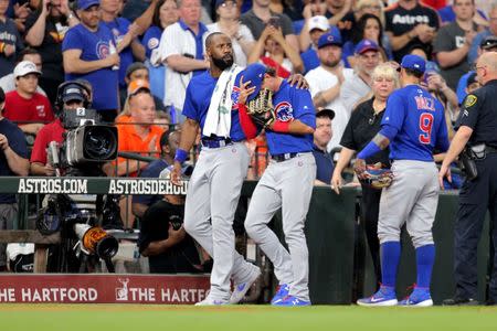 May 29, 2019; Houston, TX, USA; Chicago Cubs center fielder Albert Almora Jr. (5, center) is consoled by right fielder Jason Heyward (22, left) after a fan was hit by a foul ball during the fourth inning against the Houston Astros at Minute Maid Park. Mandatory Credit: Erik Williams-USA TODAY Sports