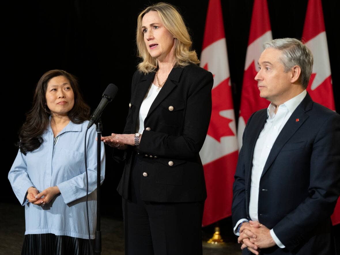 Canadian Ambassador to the United States Kirsten Hillman, centre, flanked by Minister of Export Promotion, International Trade and Economic Development Mary Ng (L) and Minister of Innovation, Science and Industry Francois-Philippe Champagne, speak to the media on Tuesday, Jan. 23, 2024. (Christinne Muschi/The Canadian Press - image credit)