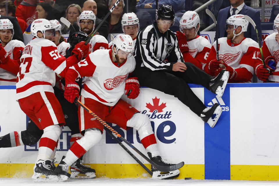 Detroit Red Wings center Michael Rasmussen (27) and linesman Jesse Marquis (86) collide during the second period of the team's NHL hockey game against the Buffalo Sabres, Thursday, Dec. 29, 2022, in Buffalo, N.Y. (AP Photo/Jeffrey T. Barnes)