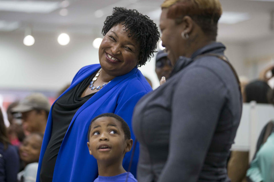 A voter speaks with gubernatorial candidate Stacey Abrams as they wait in line for their ballots during early voting at The Gallery at South DeKalb Mall in Decatur, Monday, October 22, 2018. Today marks only 15 days left until Election Day on Tuesday, November 6.(Alyssa Pointer/Atlanta Journal-Constitution via AP)