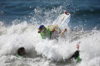 <p>A dog wipes out during the Surf City Surf Dog competition in Huntington Beach, California, U.S., September 25, 2016. REUTERS/Lucy Nicholson</p>