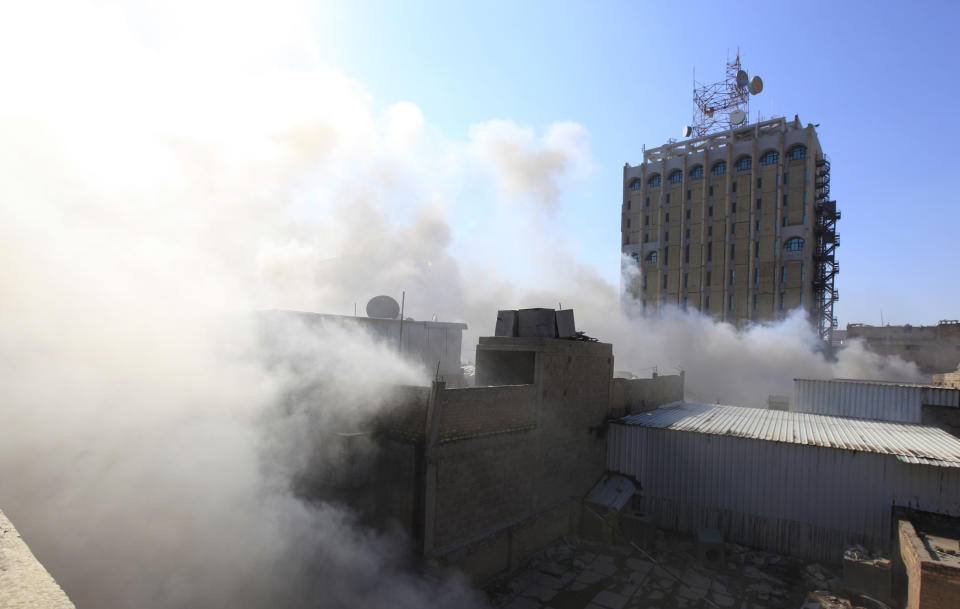 Smoke rises from the site of a bomb attack near Khullani Square in Baghdad