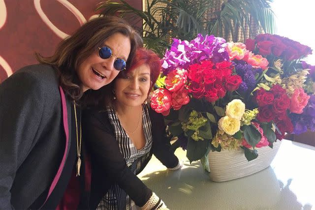 Sharon Osbourne/Instagram Ozzy Osbourne and Sharon Osbourne pose next to flowers.