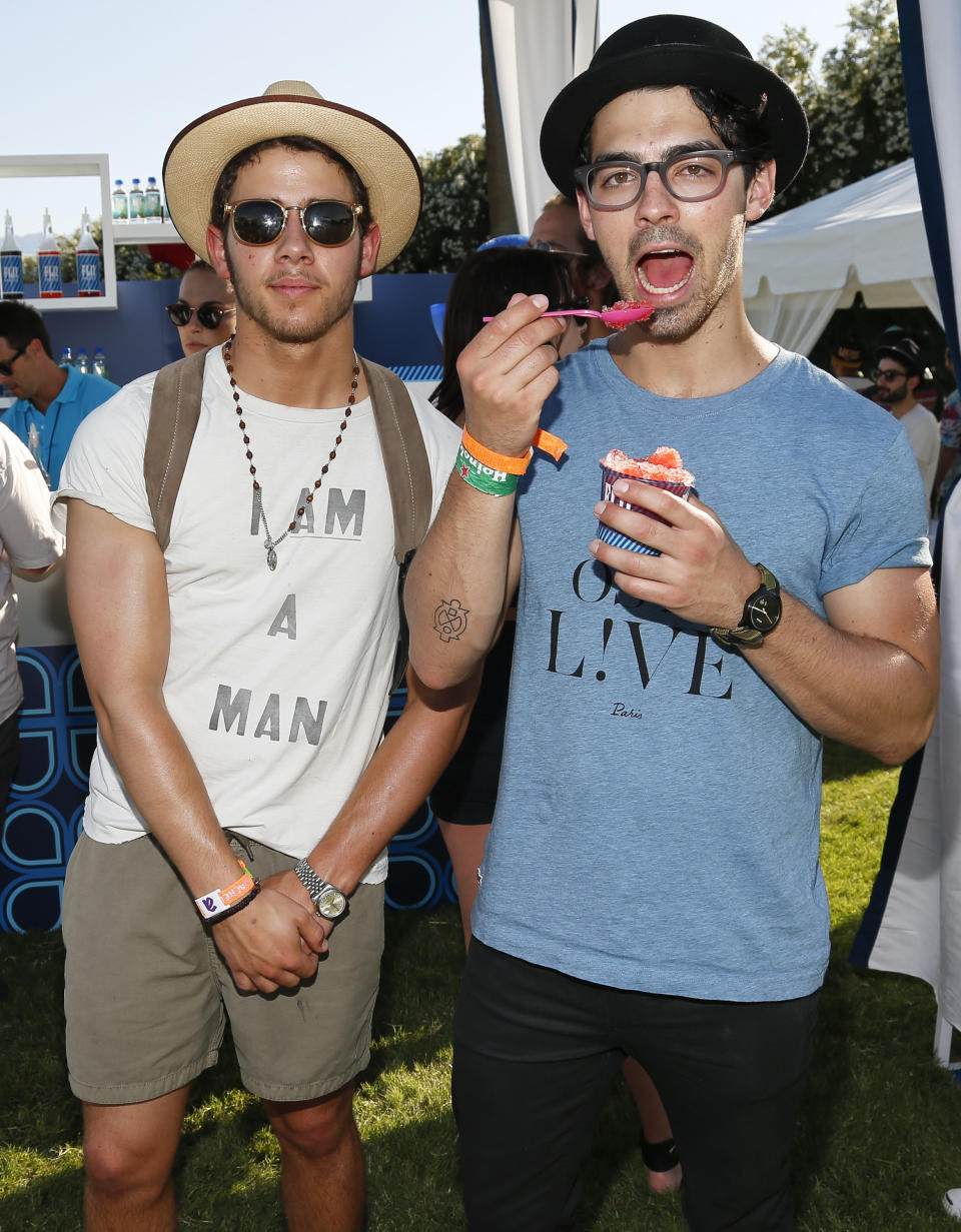 PALM SPRINGS, CA - APRIL 13:  Musicians Nick Jonas (L) and Joe Jonas of the Jonas Brothers attend the FIJI Water At Lacoste L!VE Coachella Desert Pool Party on April 13, 2013 in Palm Springs, California.  (Photo by Imeh Akpanudosen/Getty Images for FIJI)