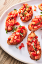 <p>Nothing screams summer quite like bruschetta. Toasted bread gets rubbed with garlic (don't skip it, it's the best part) and topped with simply marinated tomatoes. The brighter and juicier your tomatoes, the better your bruschetta will be. </p><p>Get the <a href="https://www.delish.com/uk/cooking/recipes/a30165416/best-bruschetta-tomato-recipe/" rel="nofollow noopener" target="_blank" data-ylk="slk:Classic Bruschetta;elm:context_link;itc:0;sec:content-canvas" class="link ">Classic Bruschetta</a> recipe.</p>