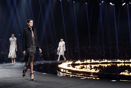 A model presents a creation from the Roberto Cavalli Autumn/Winter 2014 collection during Milan Fashion Week February 22, 2014. REUTERS/Alessandro Garofalo