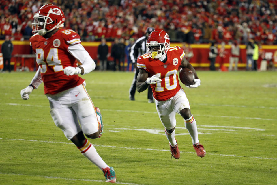 Kansas City Chiefs wide receiver Tyreek Hill (10) runs for a touchdown behind tight end Demetrius Harris (84) during the second half of an NFL football game against the Oakland Raiders in Kansas City, Mo., Sunday, Dec. 30, 2018. (AP Photo/Charlie Riedel)