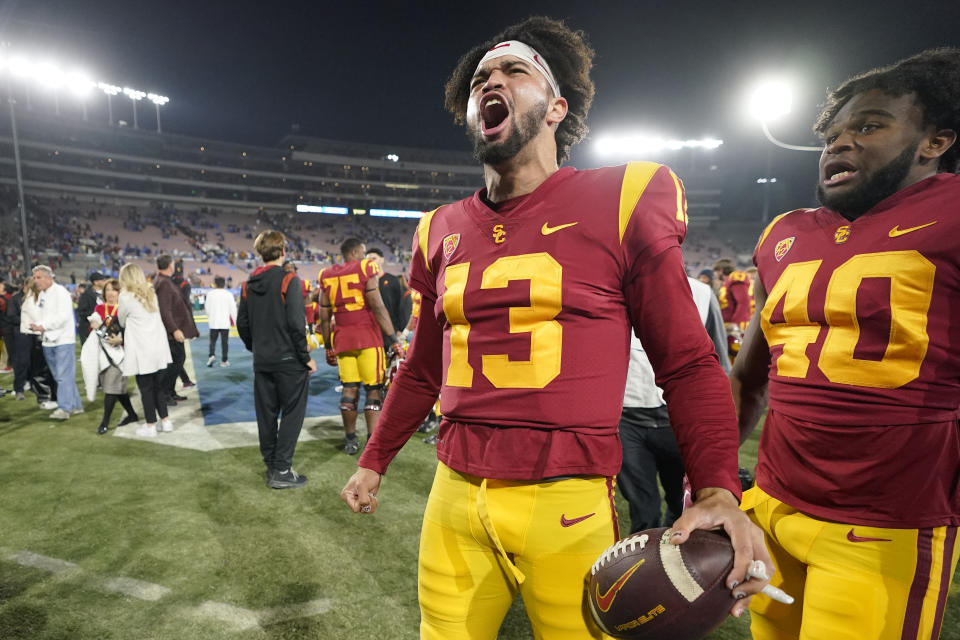 Southern California quarterback Caleb Williams, left, celebrates after USC defeated UCLA 48-45 in an NCAA college football game Saturday, Nov. 19, 2022, in Pasadena, Calif. (AP Photo/Mark J. Terrill)