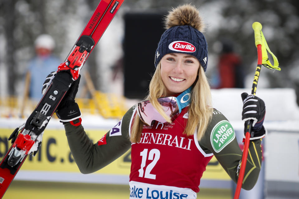 FILE - In this Dec. 7, 2019, file photo, second place finisher Mikaela Shiffrin, left, of the United States, celebrates following a women's World Cup downhill ski race in Lake Louise, Alberta. (Jeff McIntosh/The Canadian Press via AP, File)