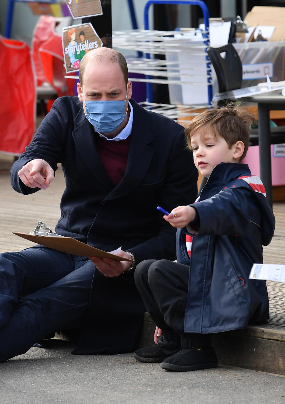 LONDON, ENGLAND - MARCH 11: Prince William, Duke of Cambridge, speaks to a young pupil in the playground during a visit to School 21 in Stratford on March 11, 2021 in London, England. The Duke and Duchess of Cambridge visited the school in east London to congratulate teachers involved in the re-opening of the school following lockdown restrictions. (Photo by Justin Tallis - WPA Pool/Getty Images)