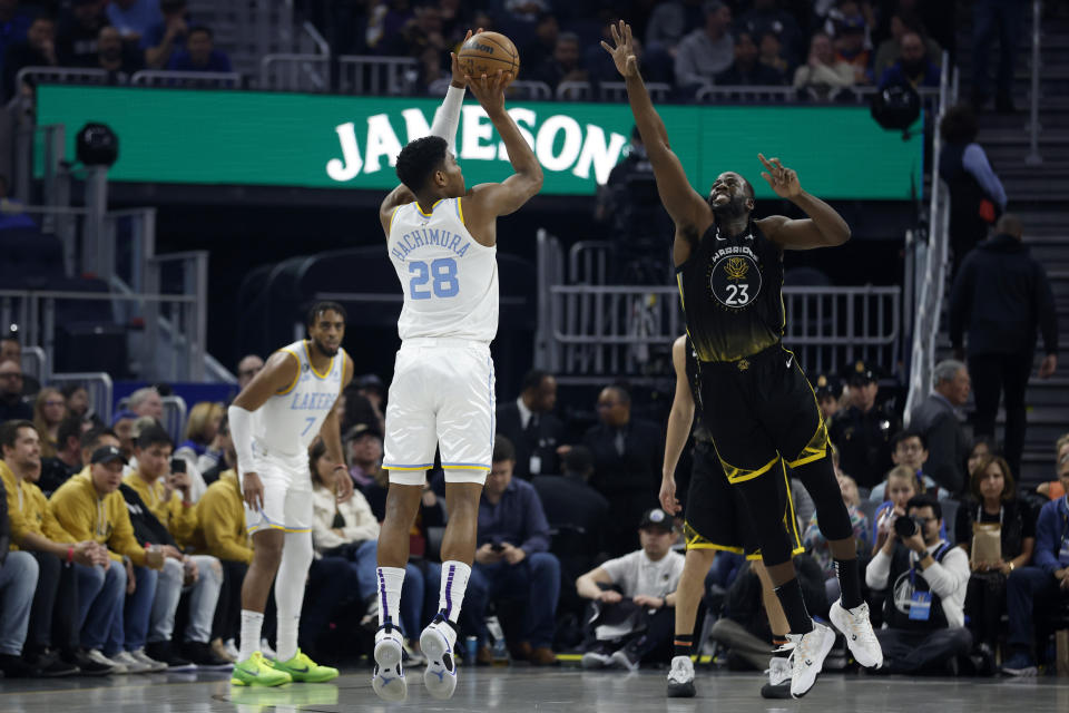 Los Angeles Lakers forward Rui Hachimura (28) shoots against Golden State Warriors forward Draymond Green (23) during the first half of an NBA basketball game in San Francisco, Saturday, Feb. 11, 2023. (AP Photo/Jed Jacobsohn)